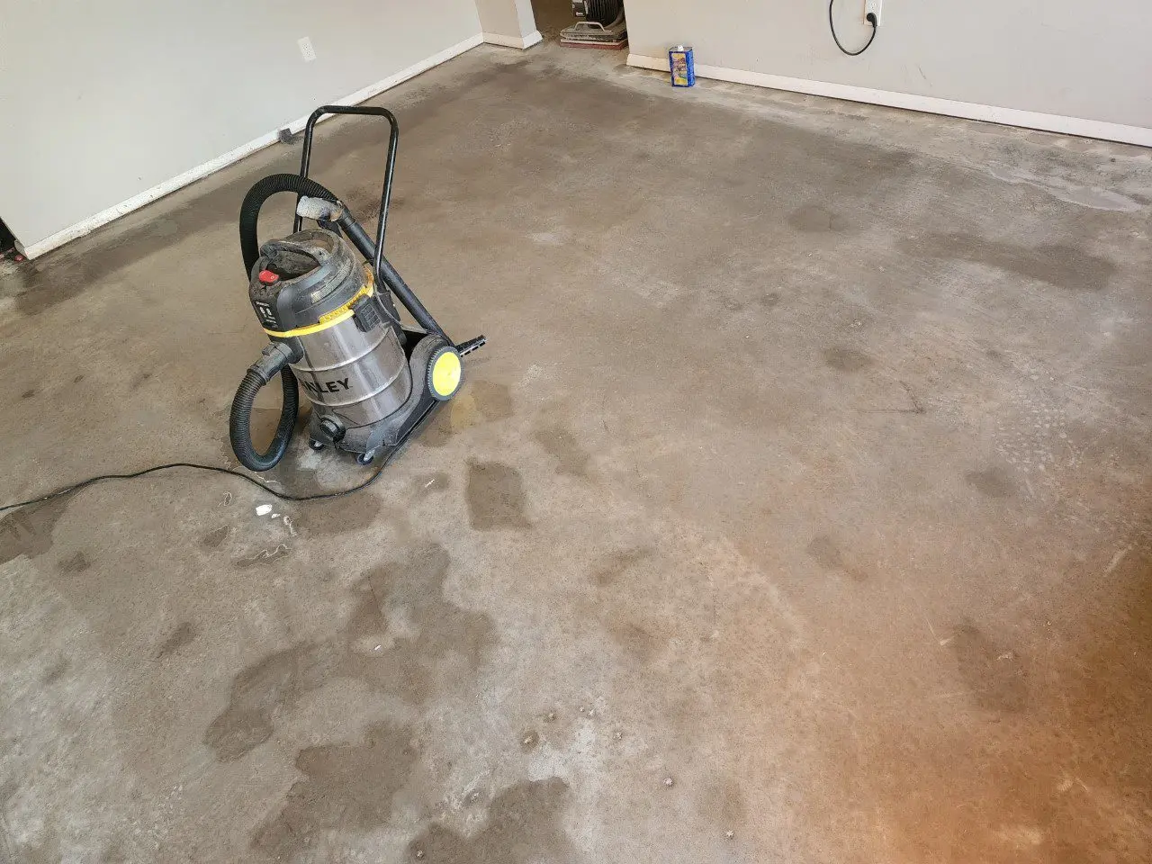 A clean and dry concrete floor achieved using a wet-vac.