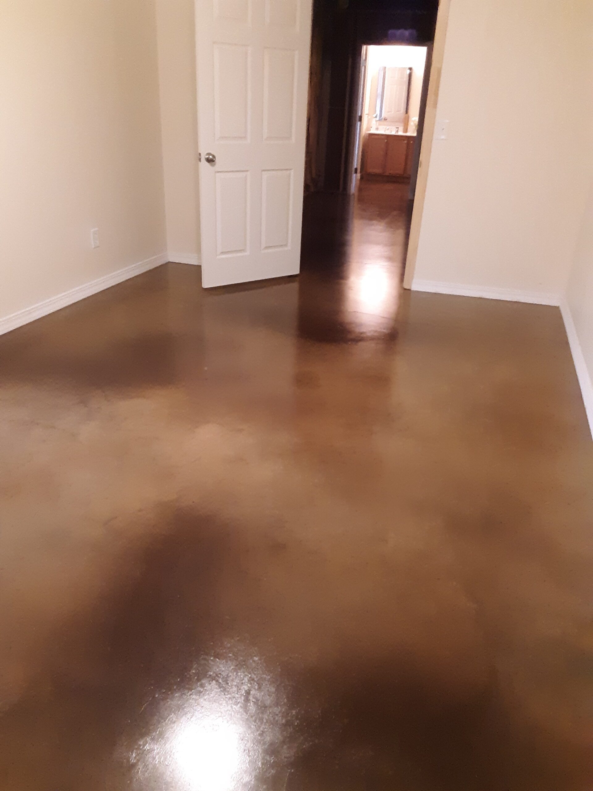 Stained concrete basement floor with aztec brown, driftwood and malayan buff Vibrance dye