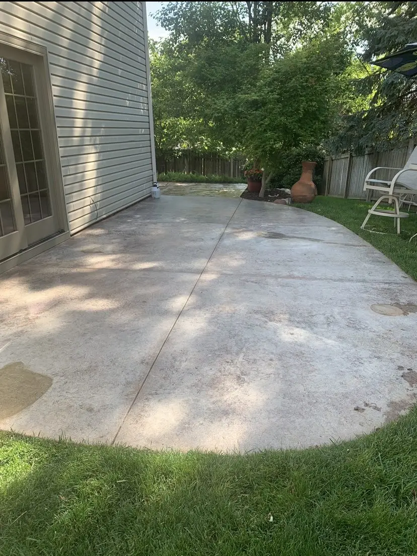 Faded concrete patio with a stamped design, cleaned and etched, ready for staining and sealing.