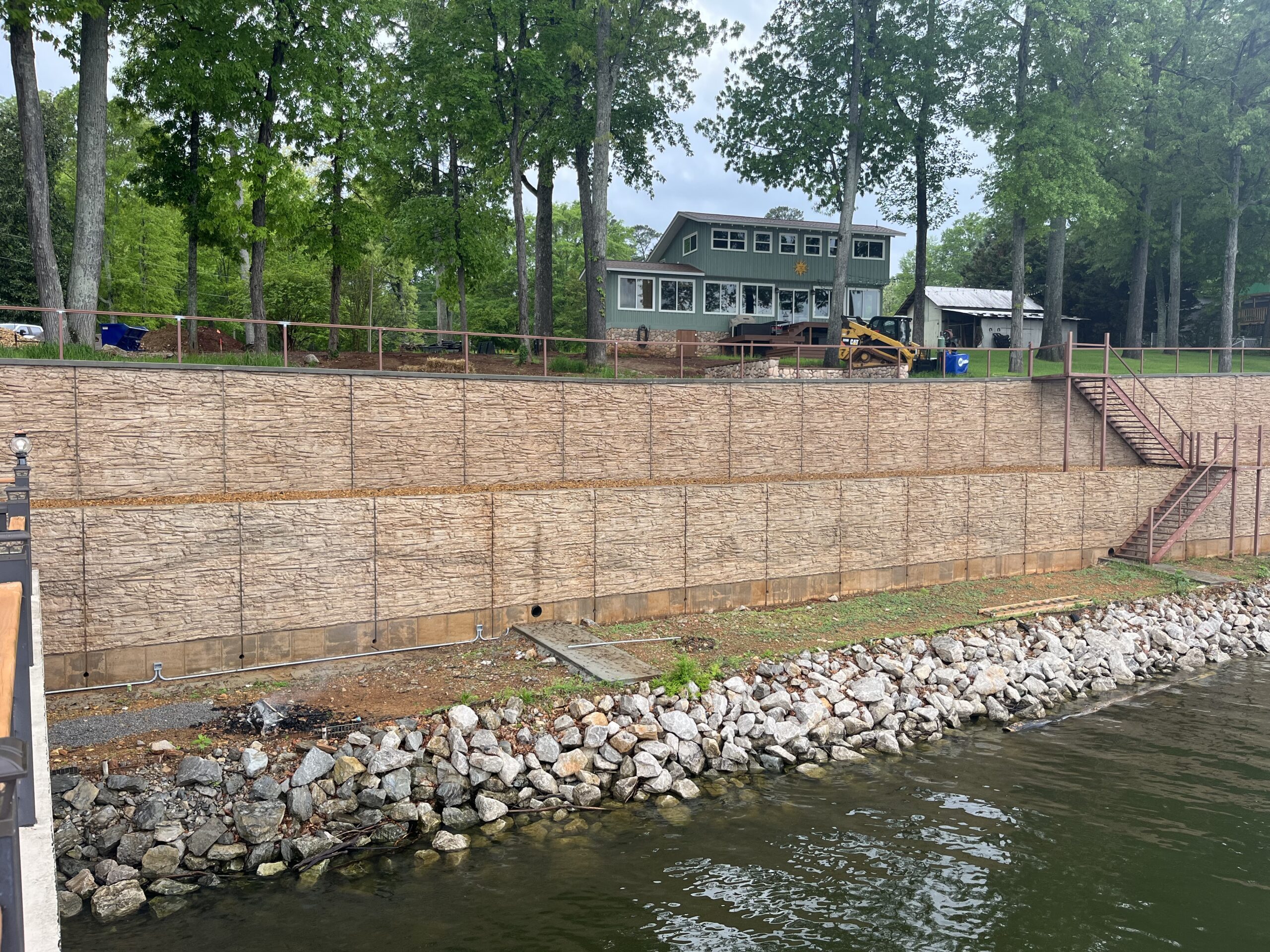 Completed staining of a large riverbank retaining wall with one coat of Cafe Royale EasyTint