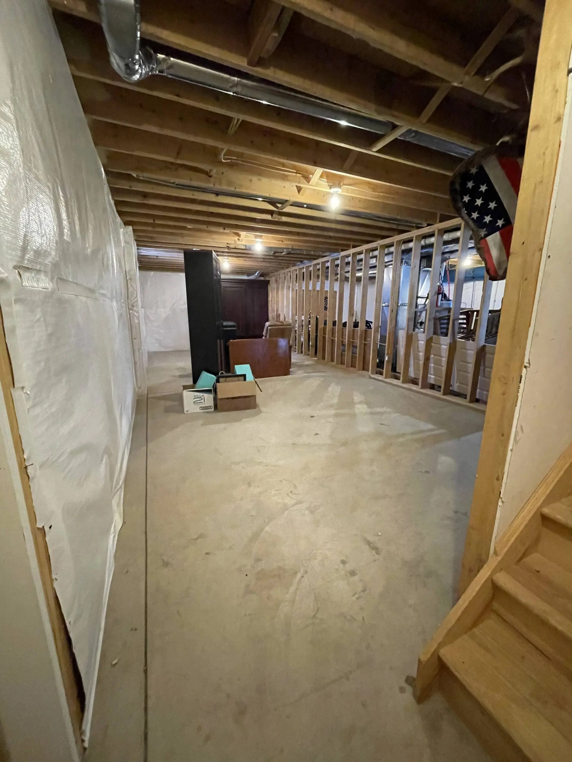 Image of the untreated concrete floor in the basement before renovation