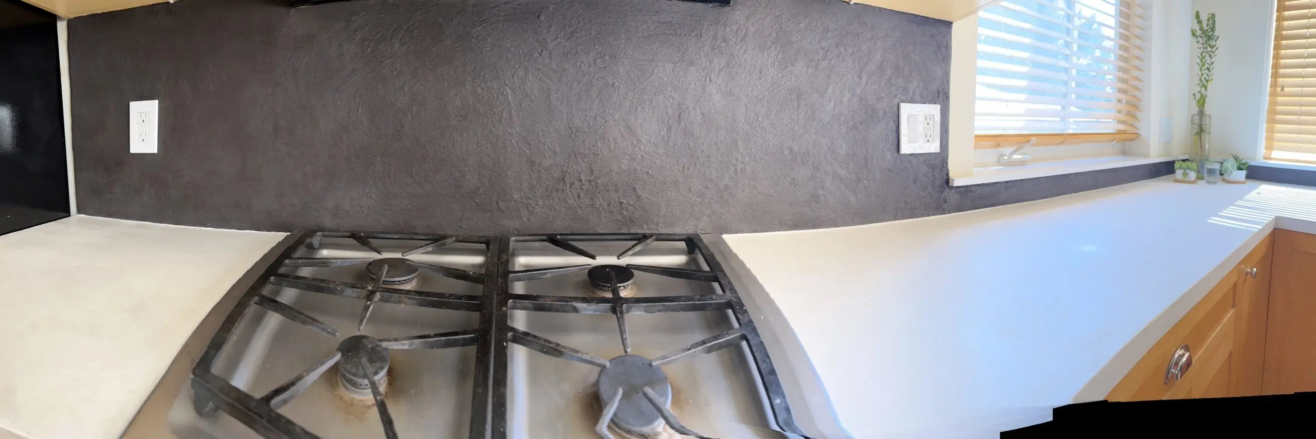 Revitalized kitchen countertop and backsplash featuring pearl white concrete overlay on Formica countertop and titanium concrete overlay on tile backsplash
