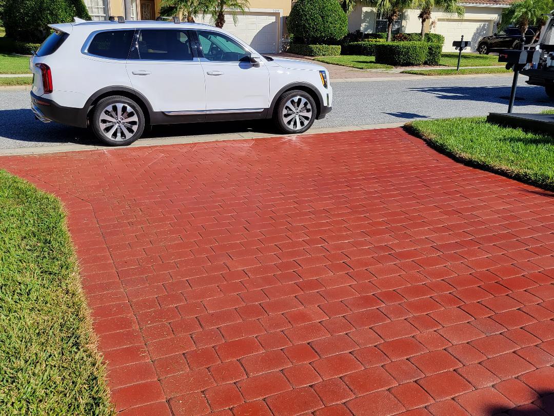 Crimson red stained concrete paver driveway with a satin finish