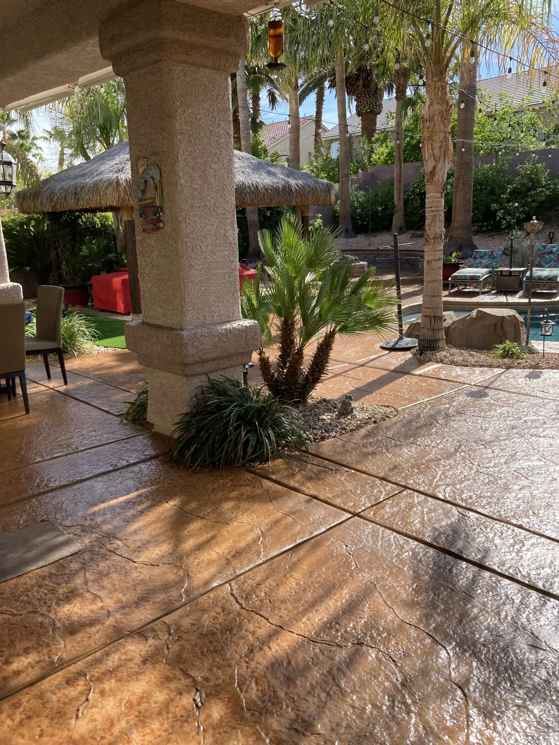 Stamped concrete pool deck with Café Royale Antiquing stain, featuring a seamless finish that enhances the poolside ambiance.