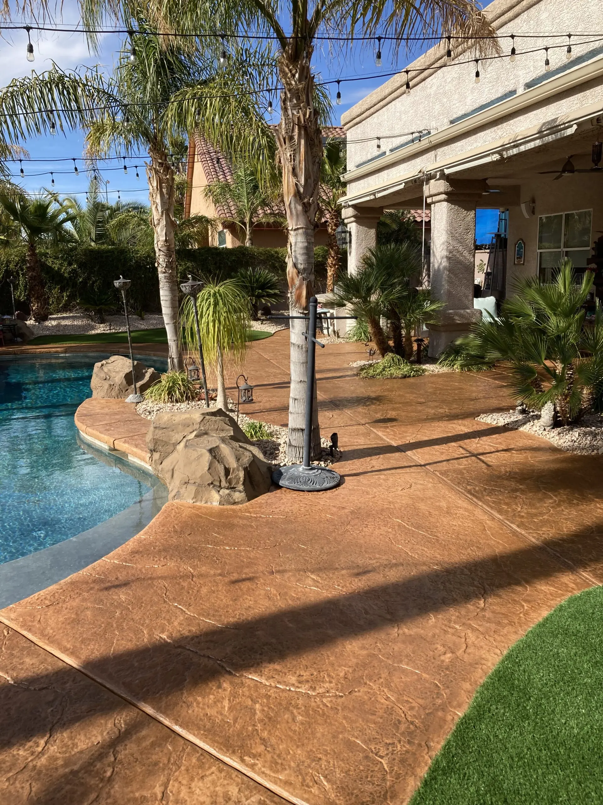 A pool deck finished with Café Royale Antiquing stain, showing a rich, earthy tone that complements the outdoor environment.