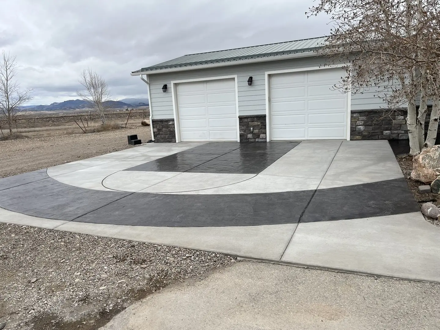 Image of a driveway stained with black EasyTint tinted sealer, featuring basketball court lines and accents.