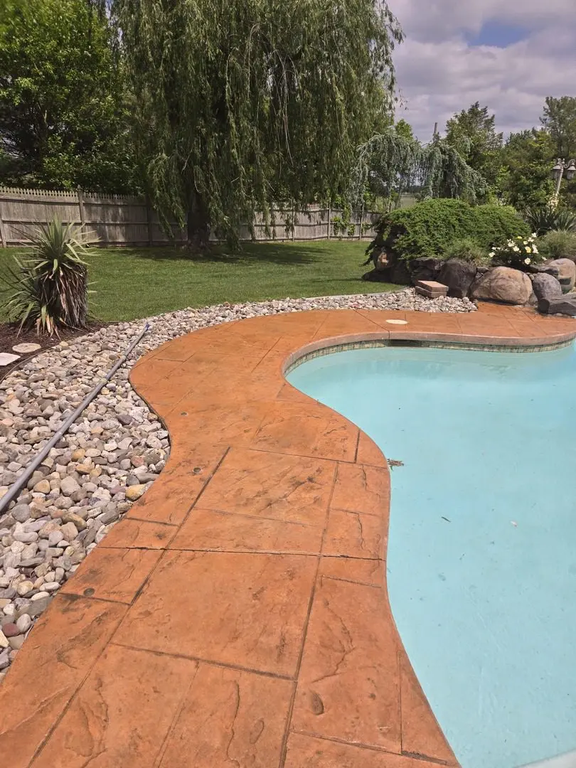 Stamped concrete pool deck fully restored with Cumin EasyTint, showing a refreshed and vibrant surface