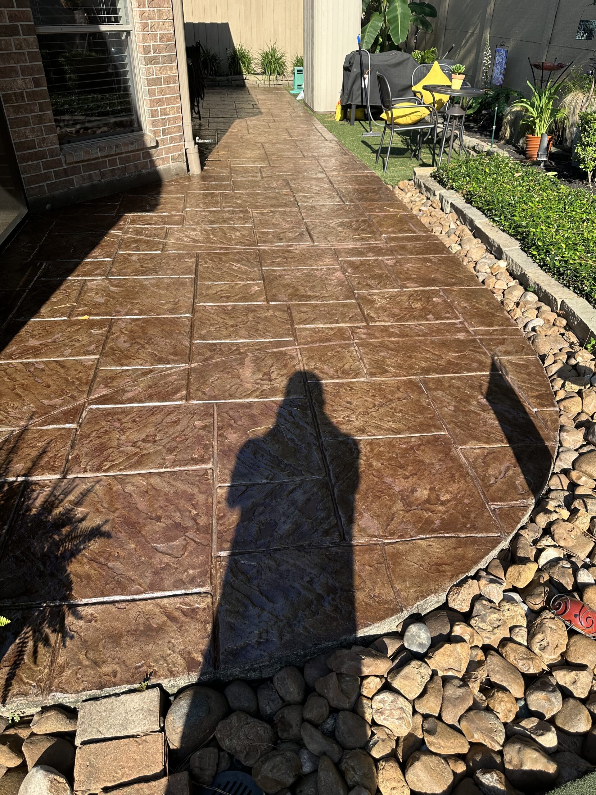 Revitalized stamped concrete surface, showcasing a consistent, refreshed color after the application of Aztec Brown Antiquing™ Stain