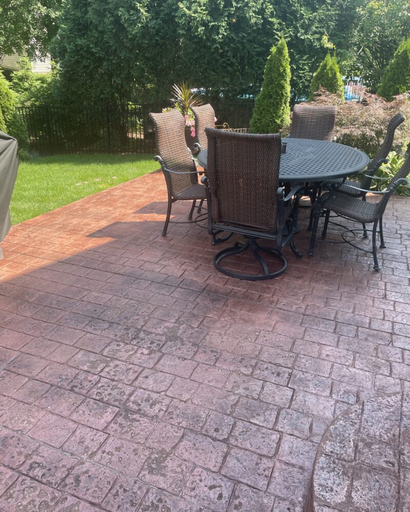 Refreshed stamped concrete surface, now sporting a rich Aztec Brown