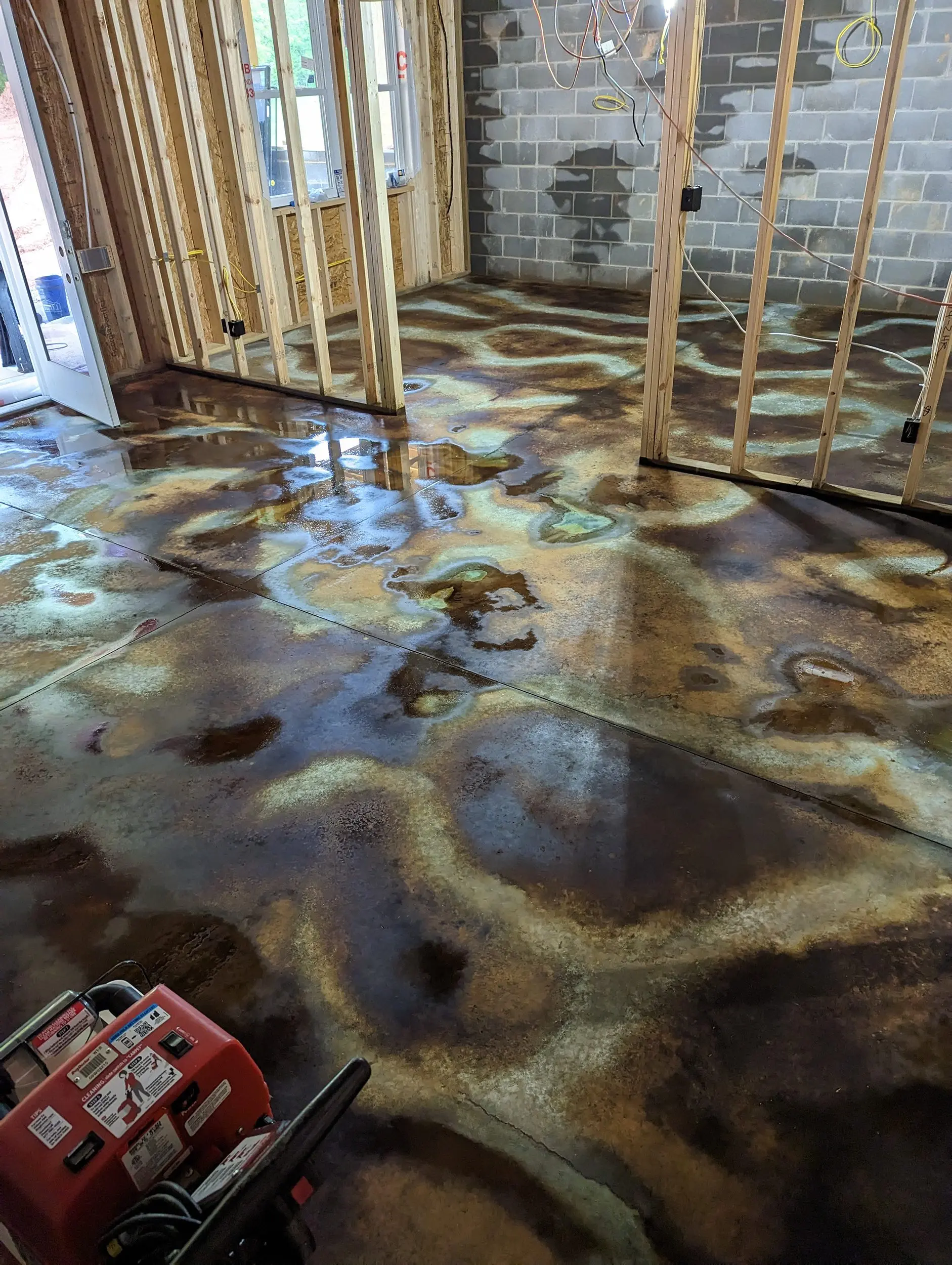 Concrete basement floor 12 hours after application of Coffee Brown, Malayan Buff, and Seagrass acid stains
