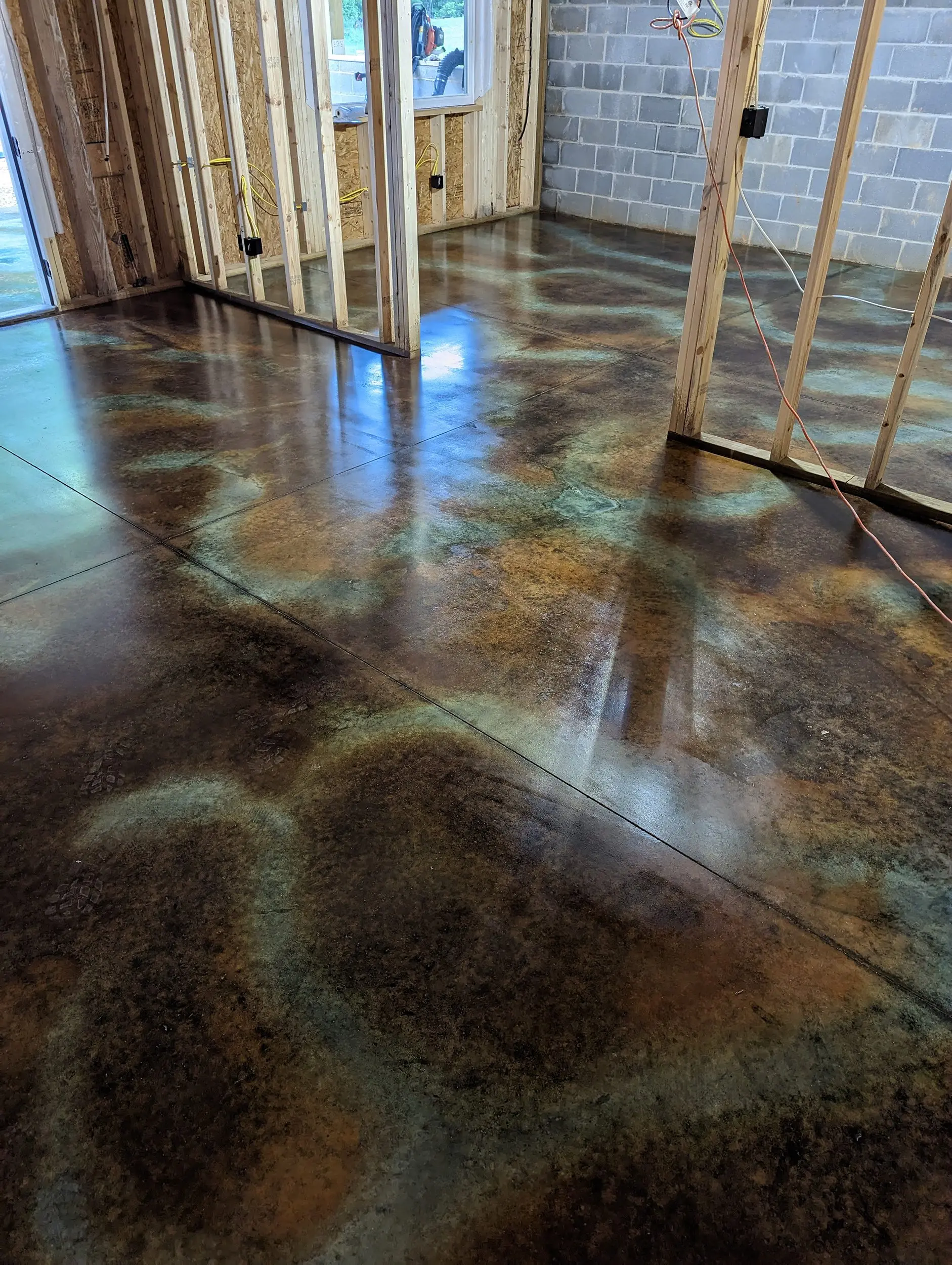 Basement floor displaying a mild luster after the application of the first coat of wax