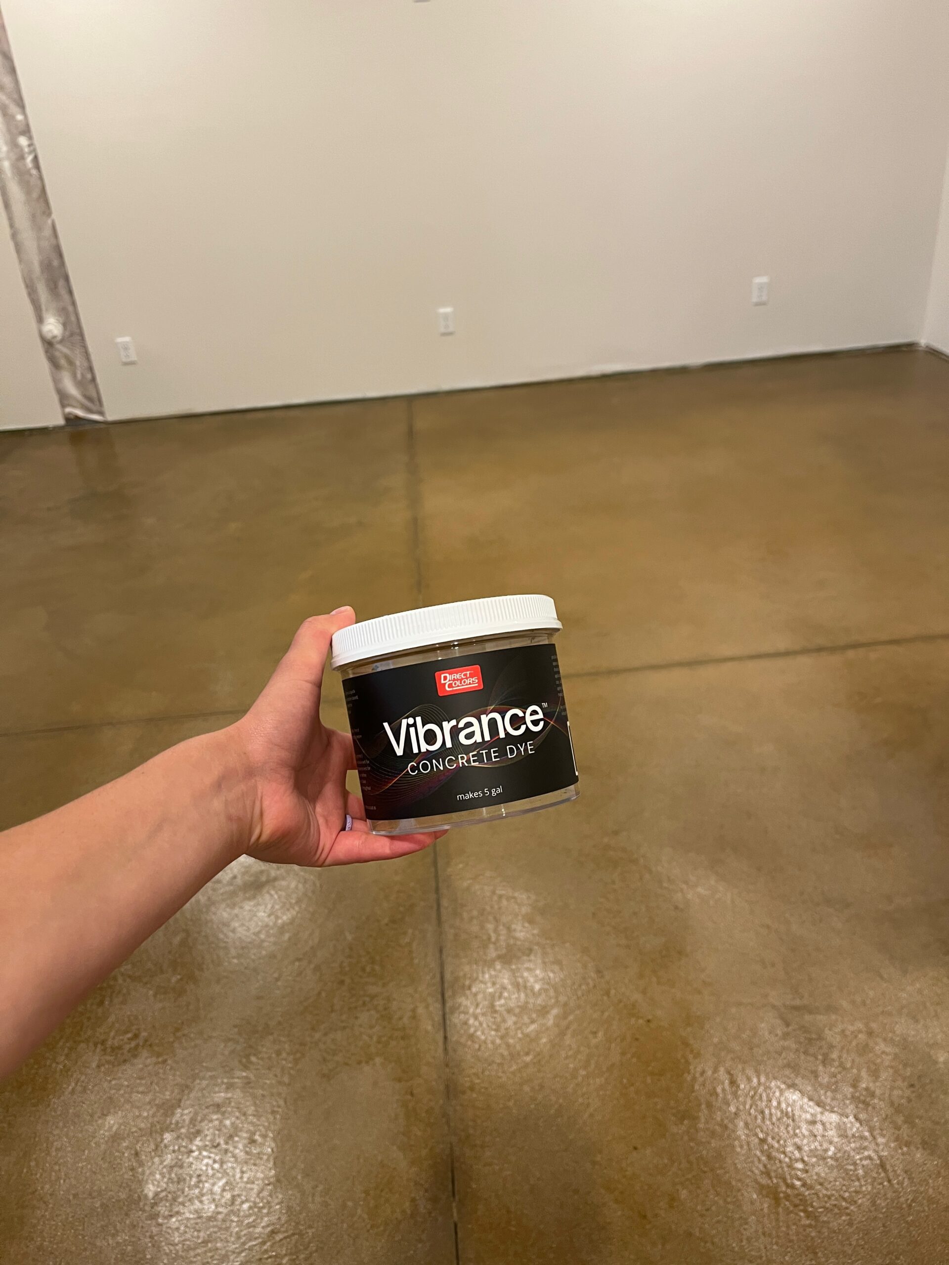 Final view of the newly dyed and sealed basement floor, with a container of Tweed Vibrance Dye on top