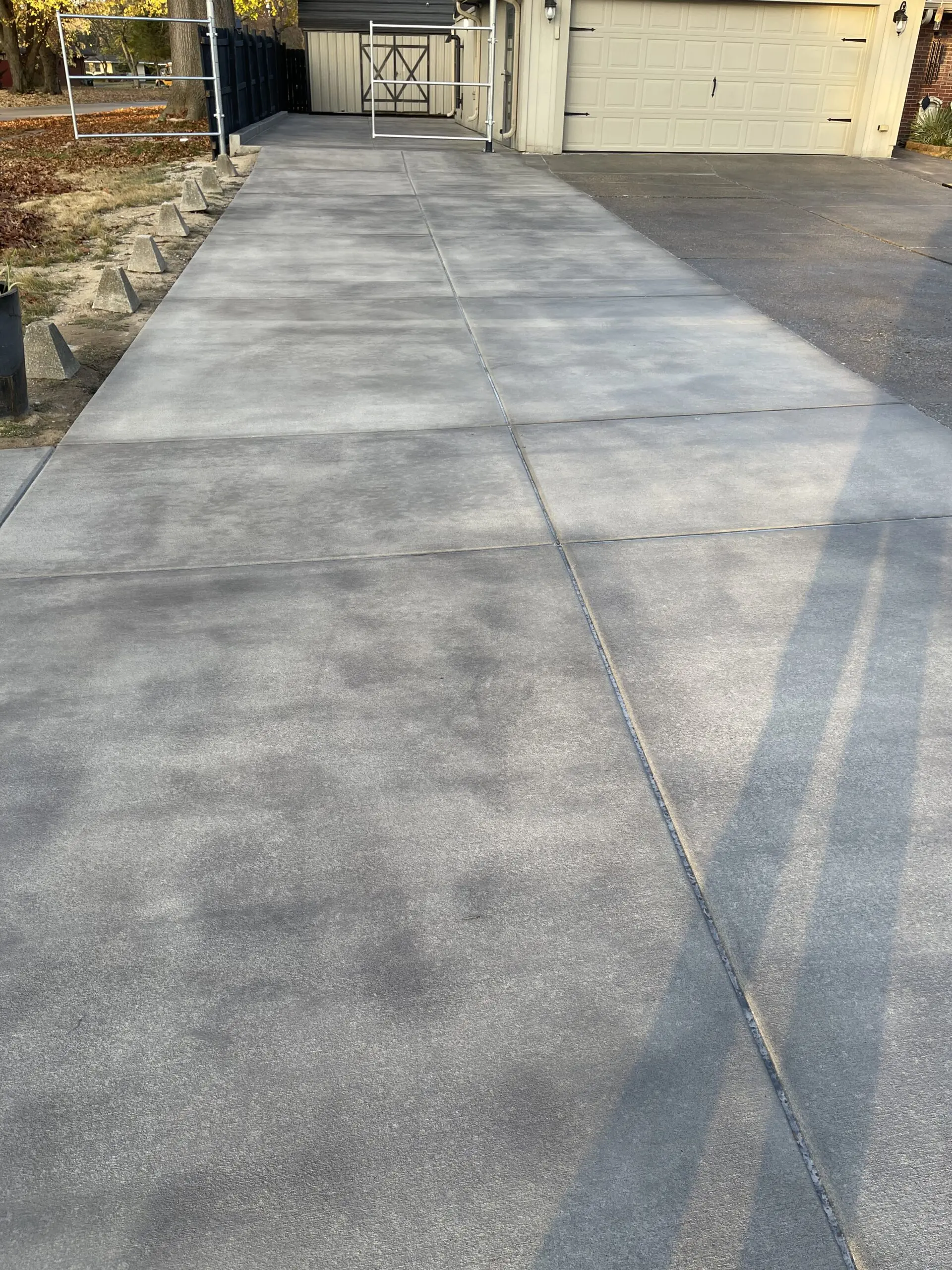 Broomed concrete driveway after being stained with Light Charcoal Antiquing, showing a rich and even color enhancement.