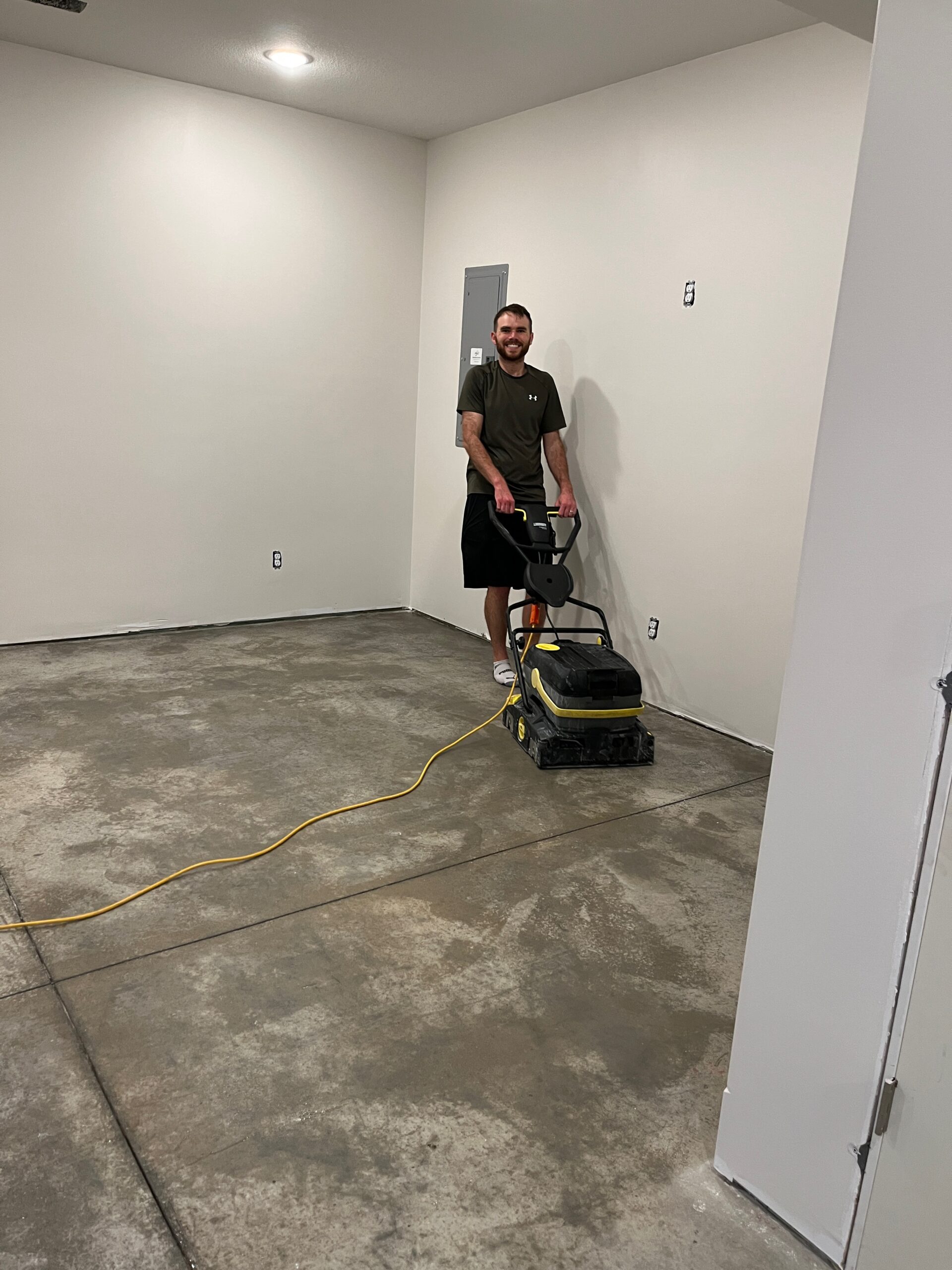 Customer mechanically scrubbing the concrete floor for thorough cleaning