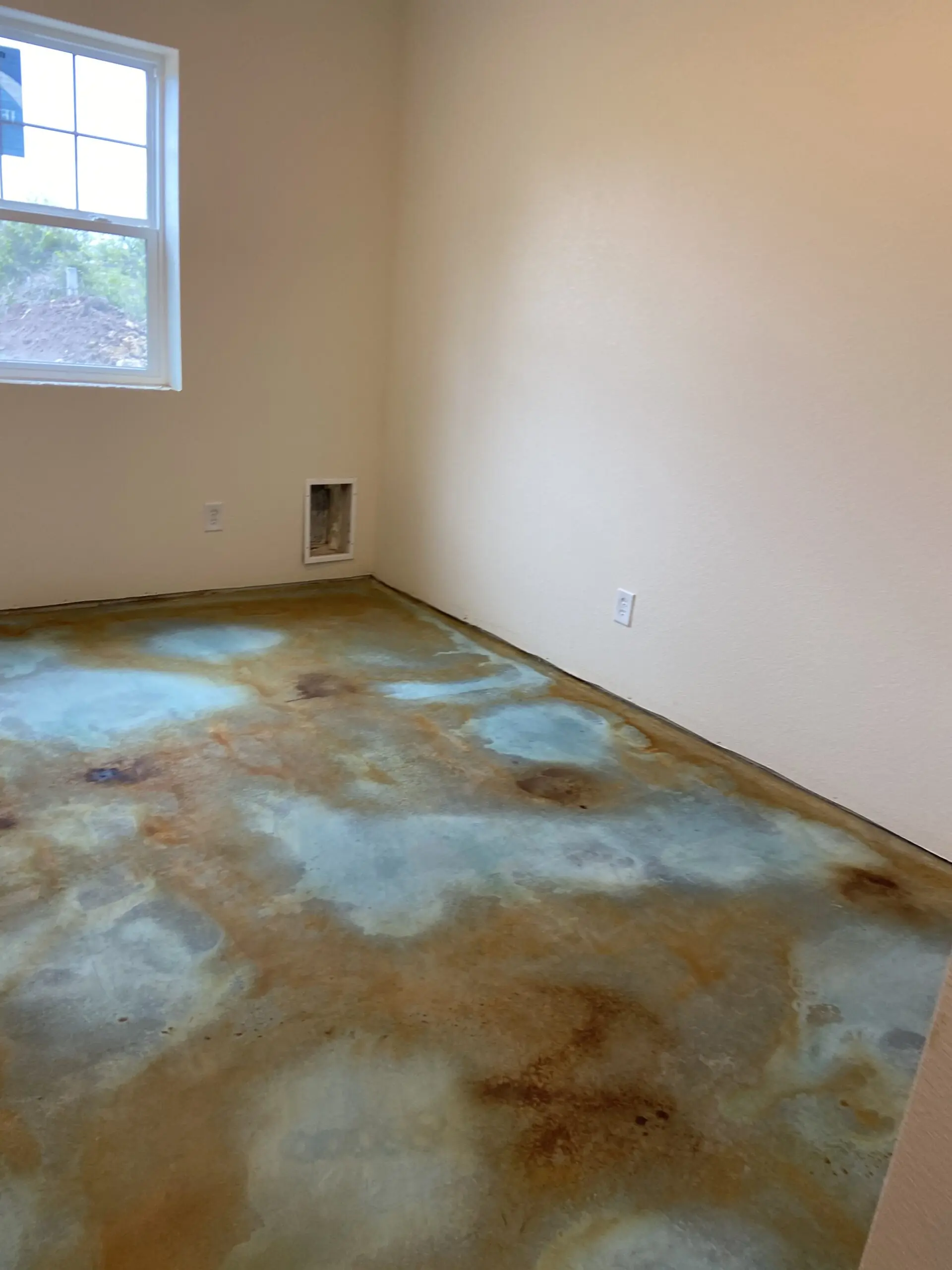 A photograph showing the stained concrete floor after the acid stains have reacted, have been neutralized, and cleaned