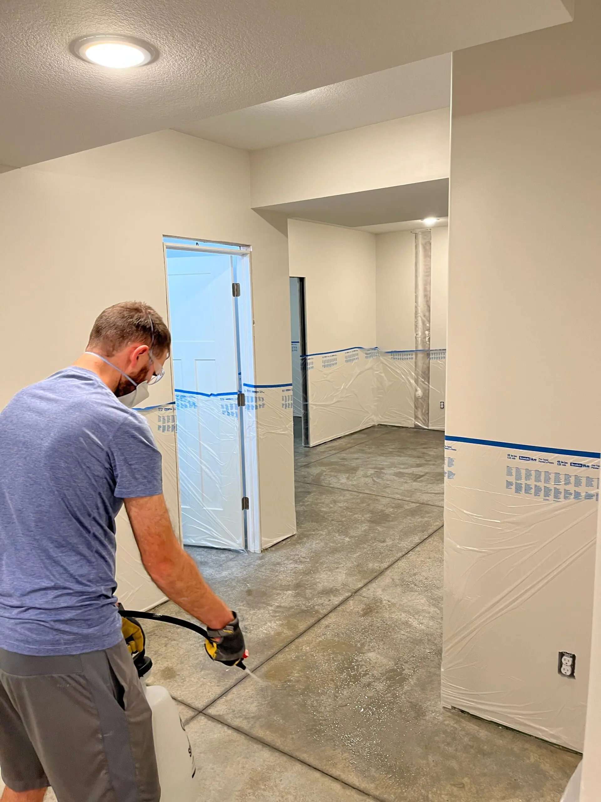 Customer spraying CitrusEtch concrete etcher onto the basement floor