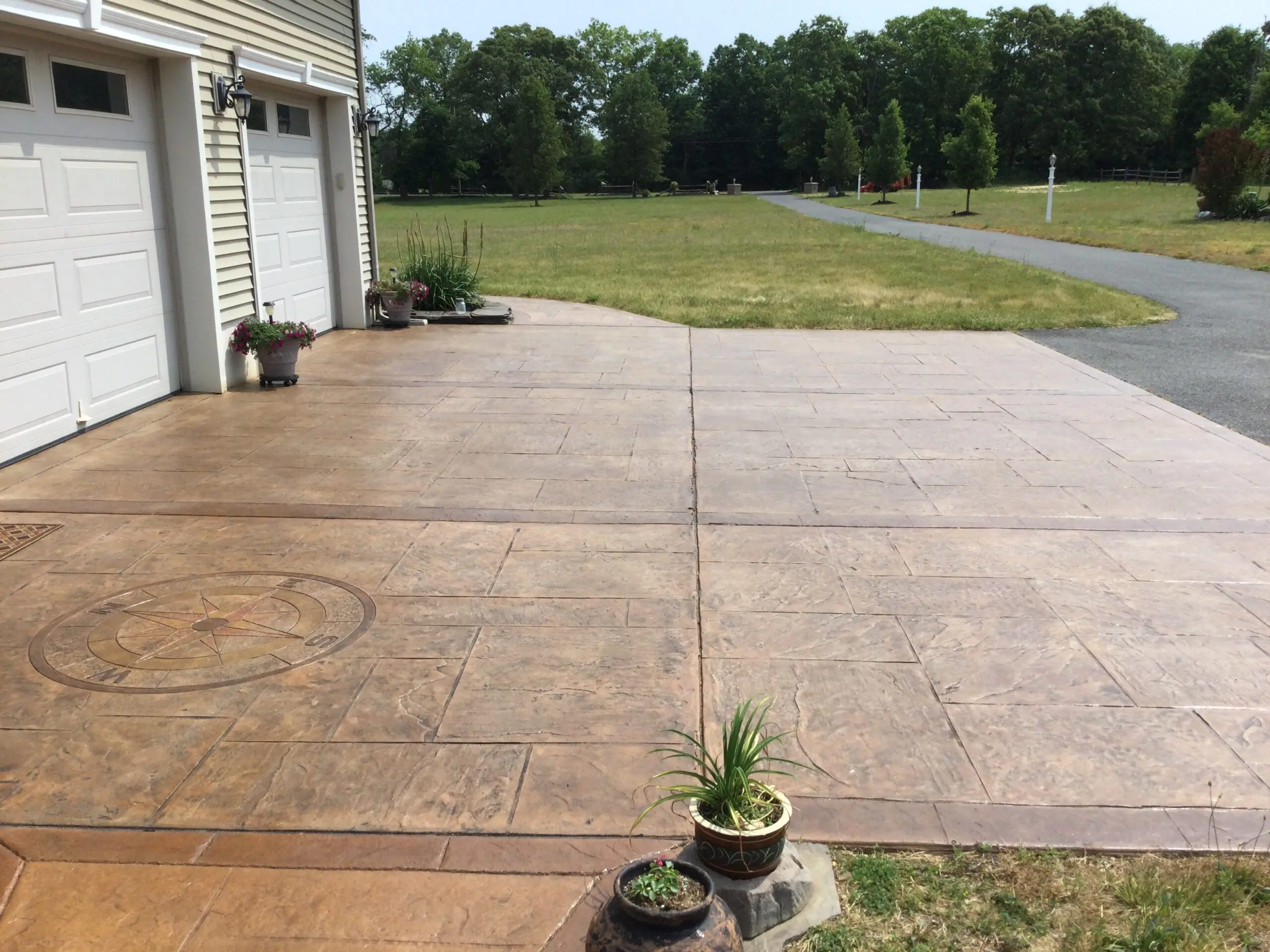 The refreshed driveway post application of Driftwood and Cafe Royale stain, showing a vibrant, renewed surface