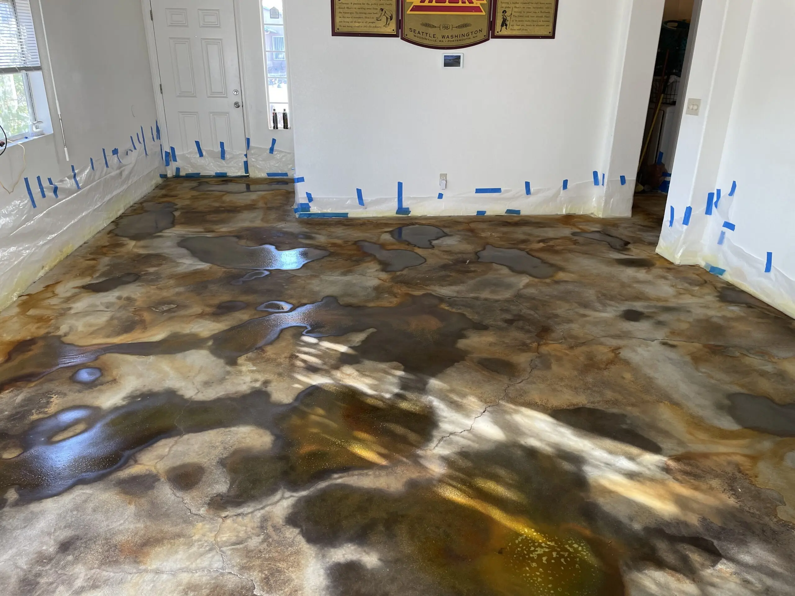 A photo showing the living room floor post-application of the Black, Malayan Buff, and Seagrass EverStain acid stains