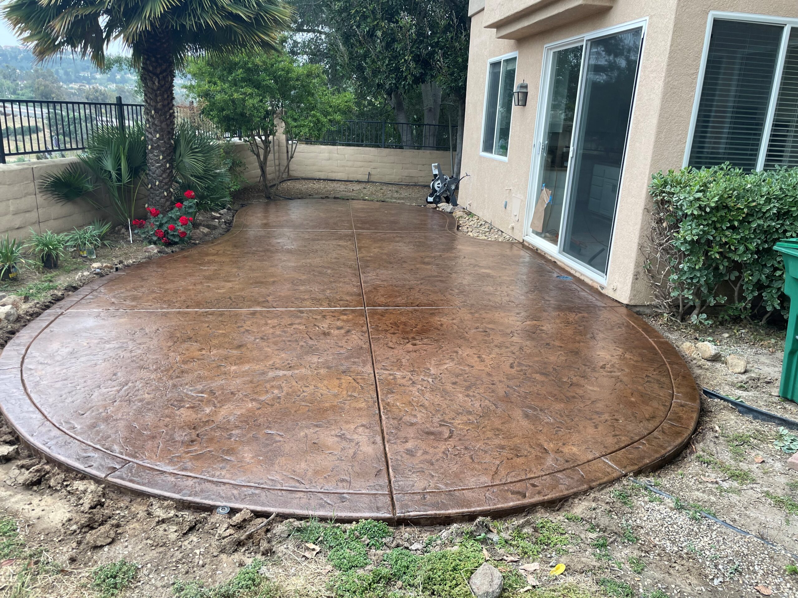 Backyard patio after sealer application, showcasing an enhanced color depth and a glossy finish