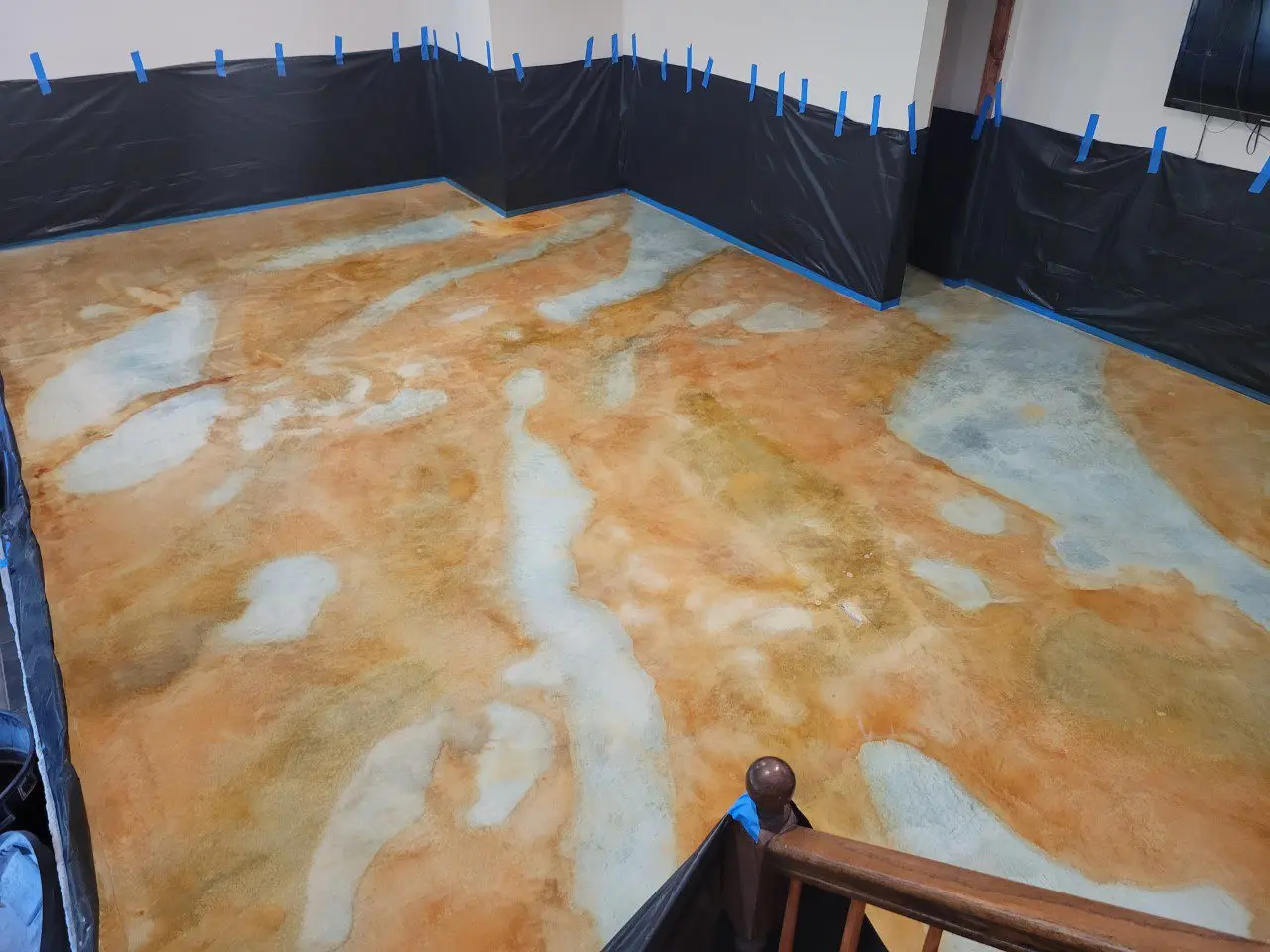 A fully stained basement floor, after allowing the acid stains to react overnight