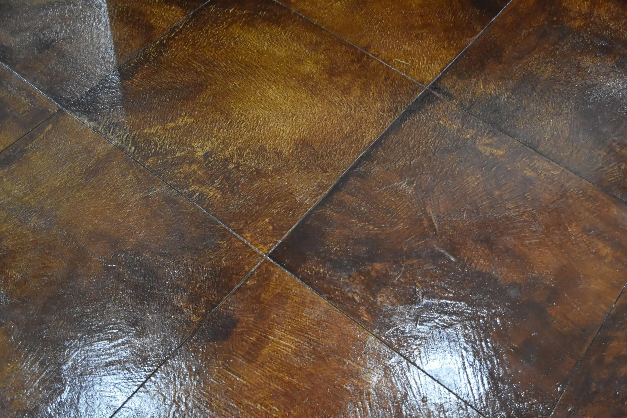 Concrete floor with a rich Terracotta stain and glossy finish.