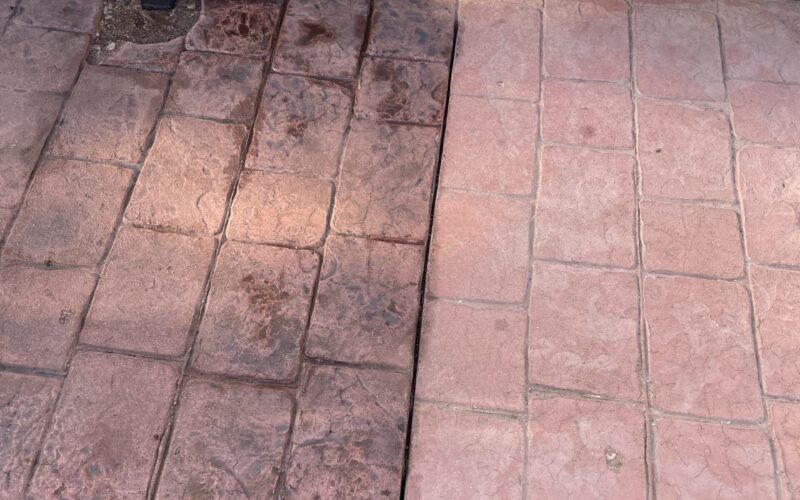 Stamped concrete surface half stained with Aztec Brown antique stain and half remaining in its previous chalky pink state