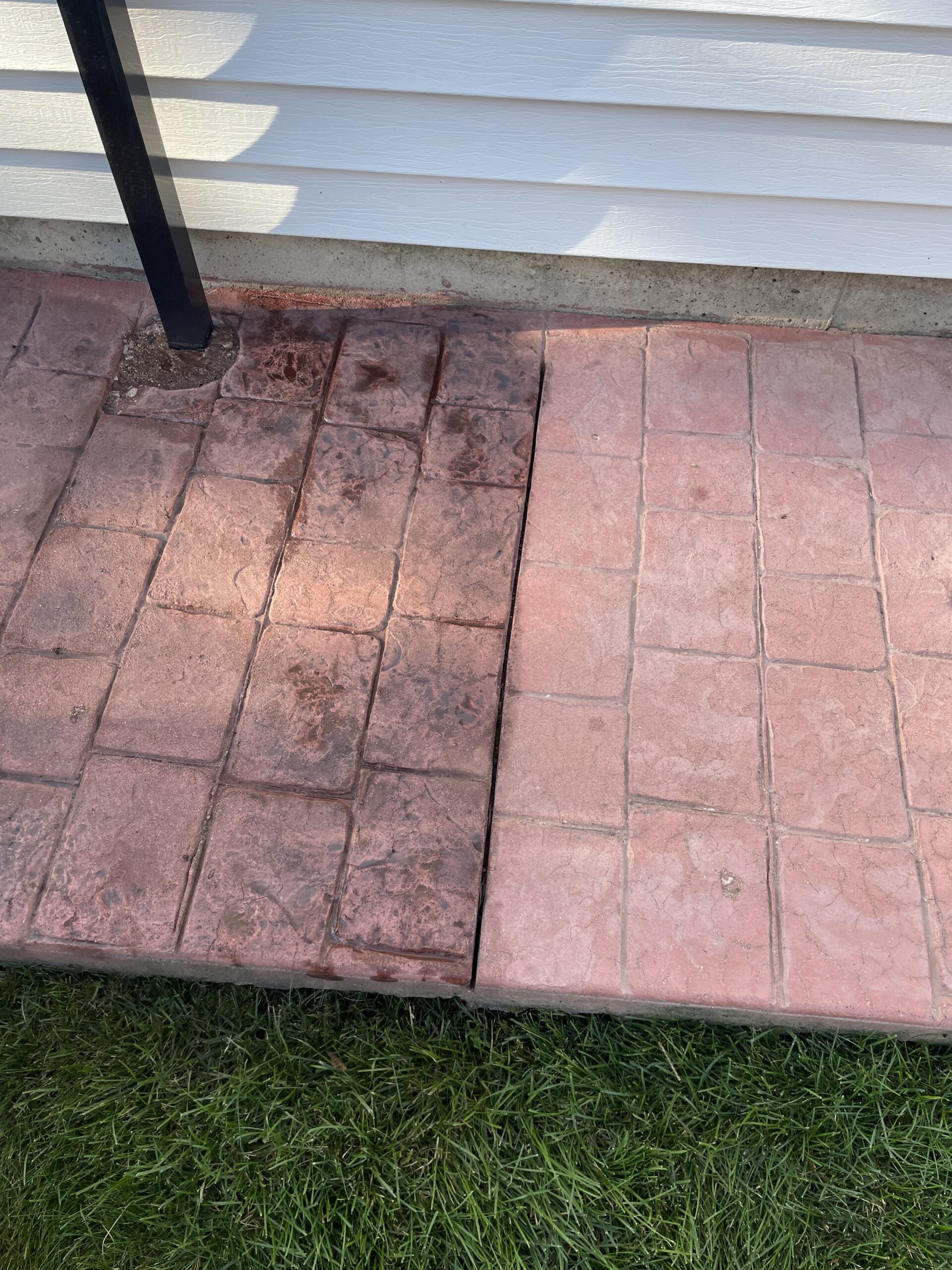 Stamped concrete surface half stained with Aztec Brown antique stain and half remaining in its previous chalky pink state Stamped concrete surface half stained with Aztec Brown antique stain and half remaining in its previous chalky pink state