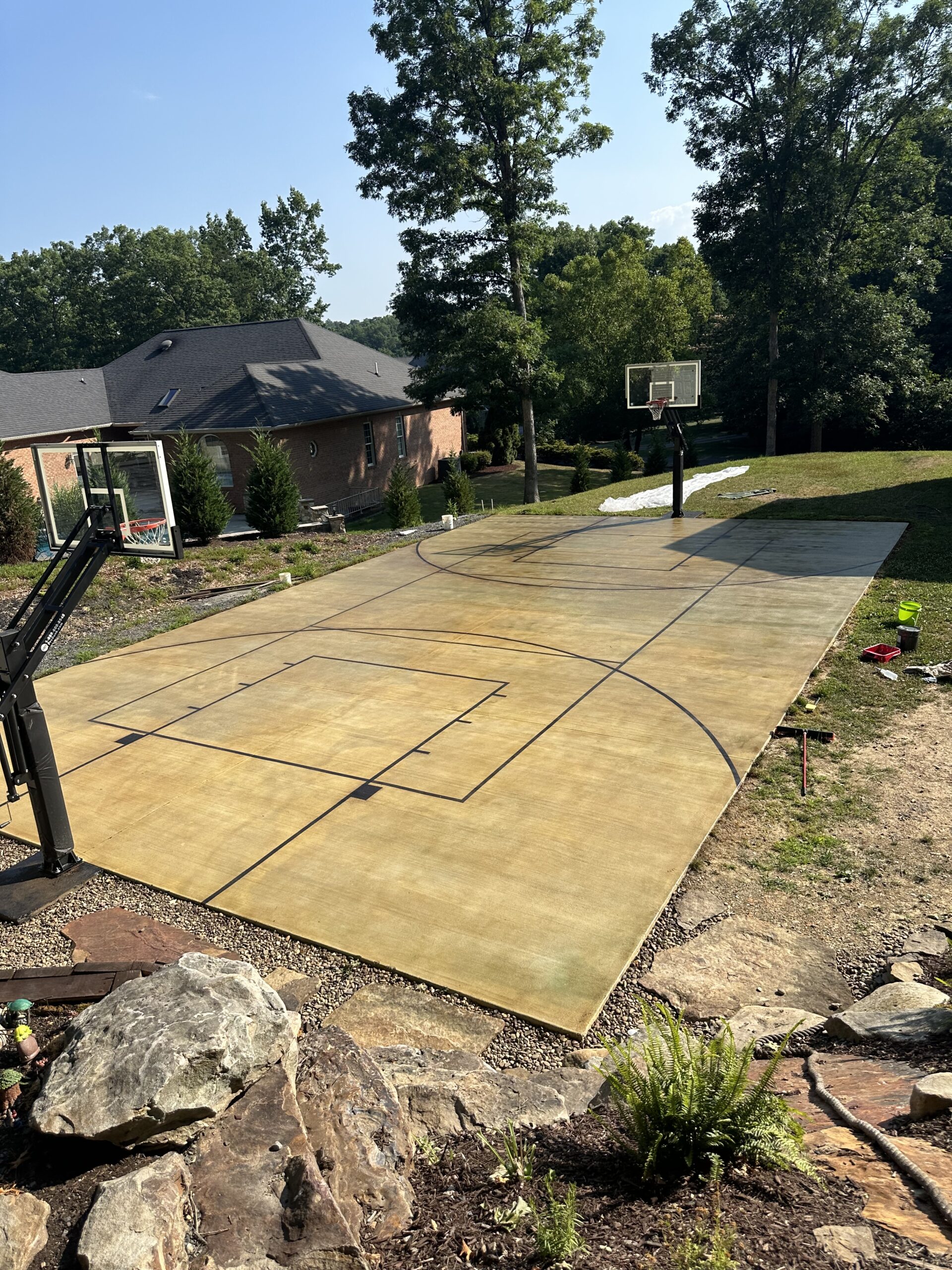 The finished basketball court, featuring clear, sharp lines and a warm, golden-brown surface