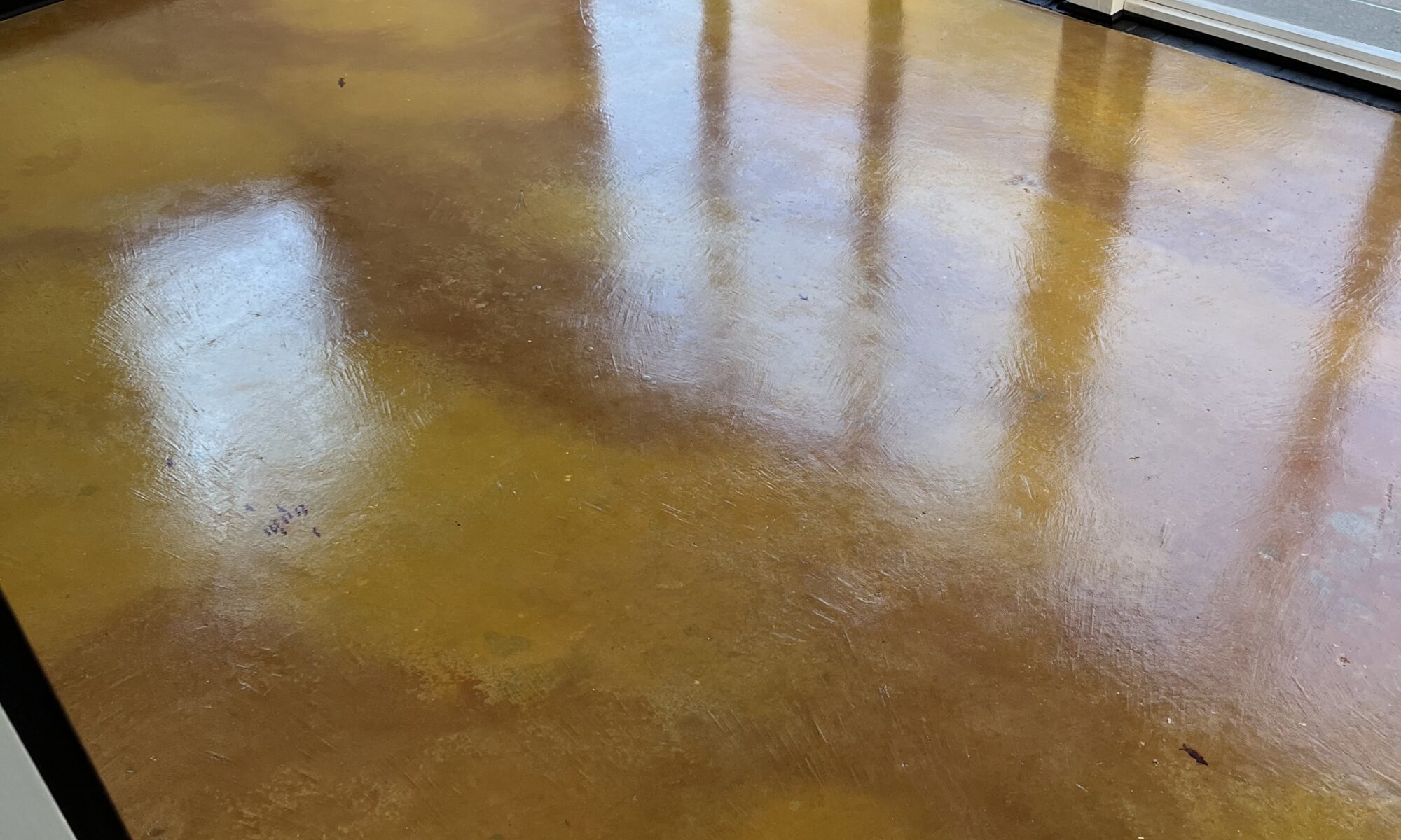 A sunroom floor with a marbled effect created using Cumin and Wheat tints, resembling a pond.