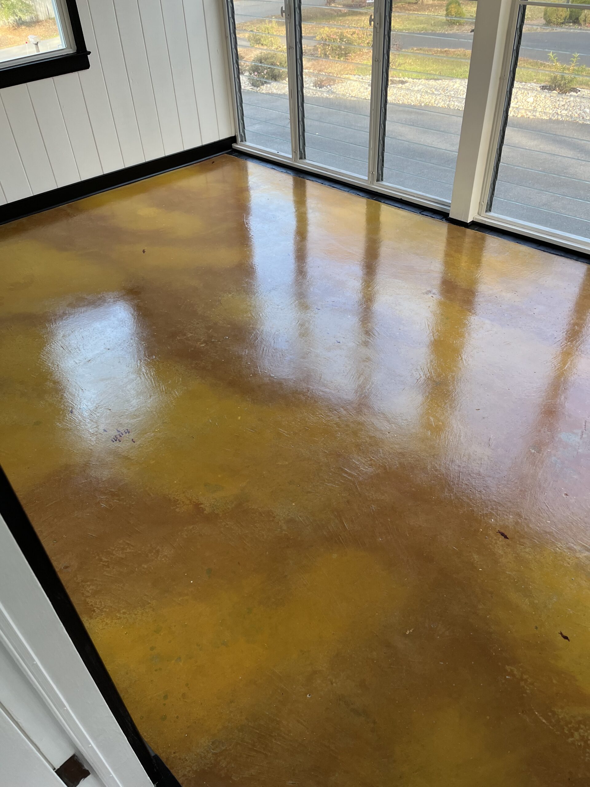 A sunroom floor with a marbled effect created using Cumin and Wheat tints, resembling a pond.