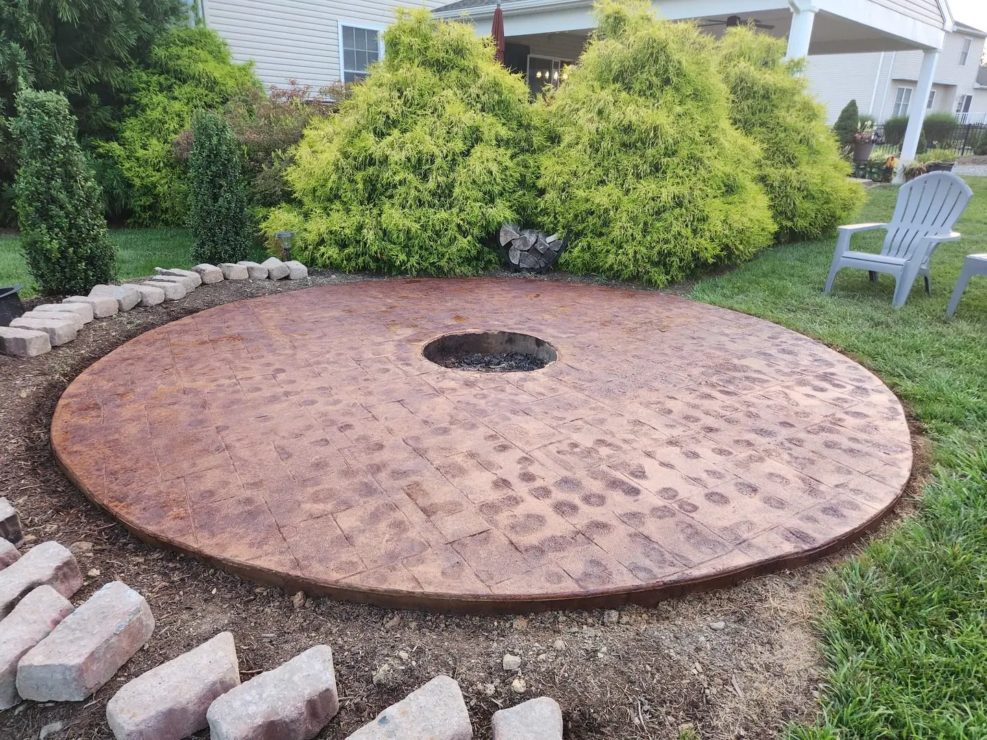 Circular concrete fire pit patio stained in ColorWave Rust