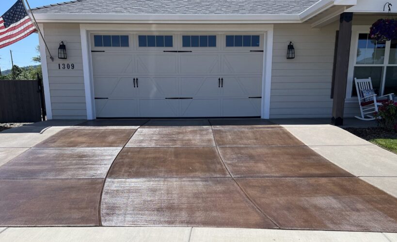 Concrete driveway after staining, featuring rich Aztec Brown and Molasses tones