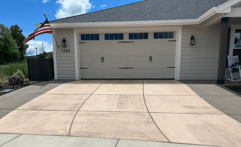 Concrete driveway before staining, showing a pale pinkish tone