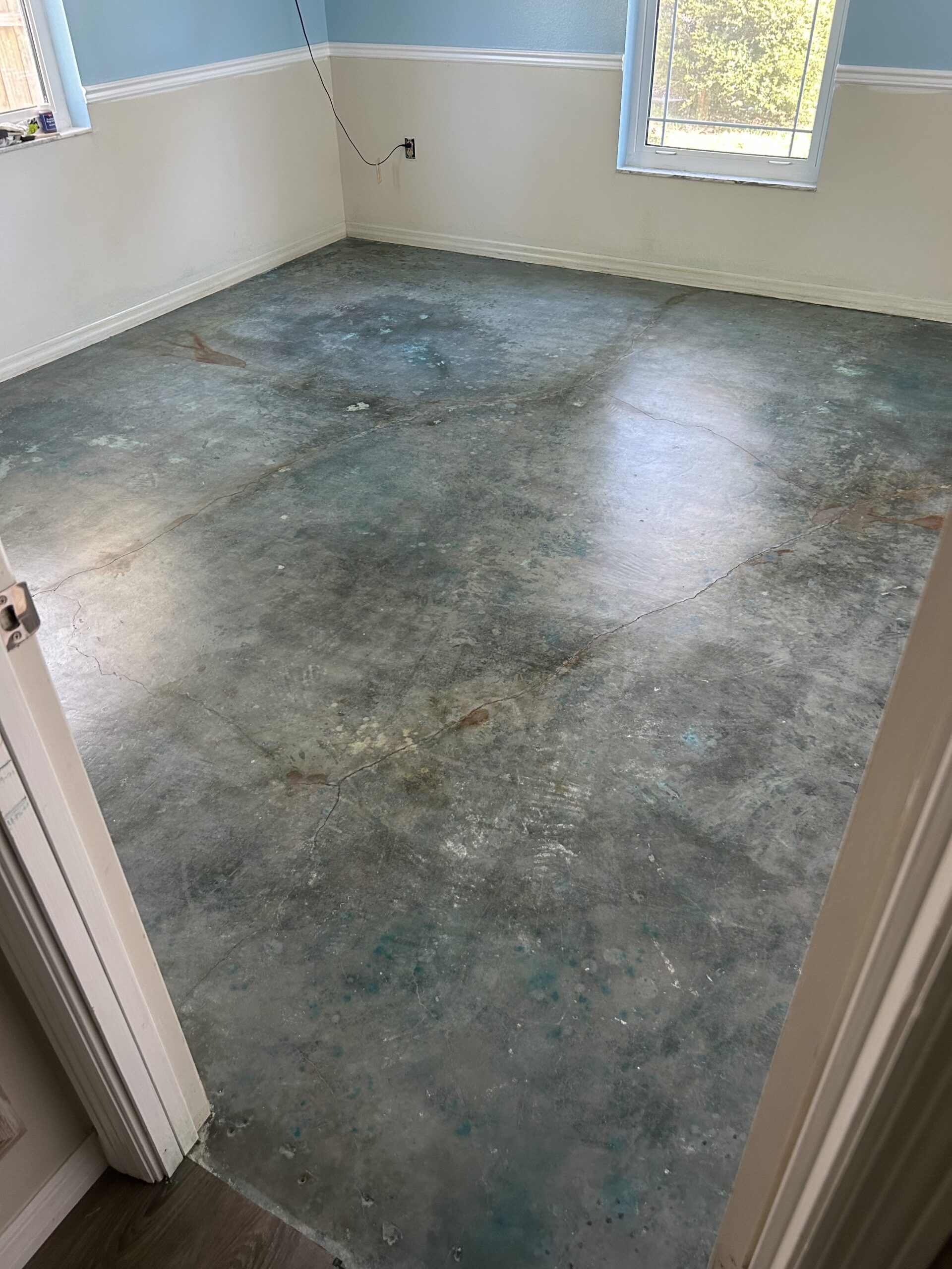 Completed bedroom floor with two light coats of satin sealer applied, showcasing the vibrant Azure Blue finish and natural crack accents