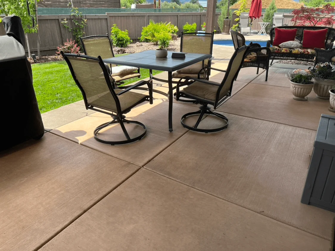 Patio with Molasses-stained concrete and outdoor seating area