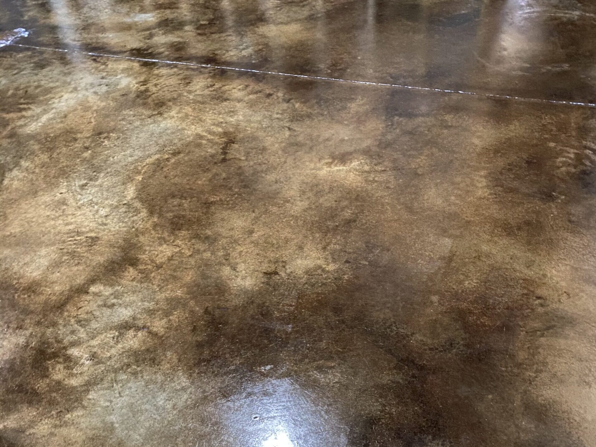 EverStain acid-stained concrete floors with a rich, leather-like appearance in Coffee Brown and Desert Amber tones