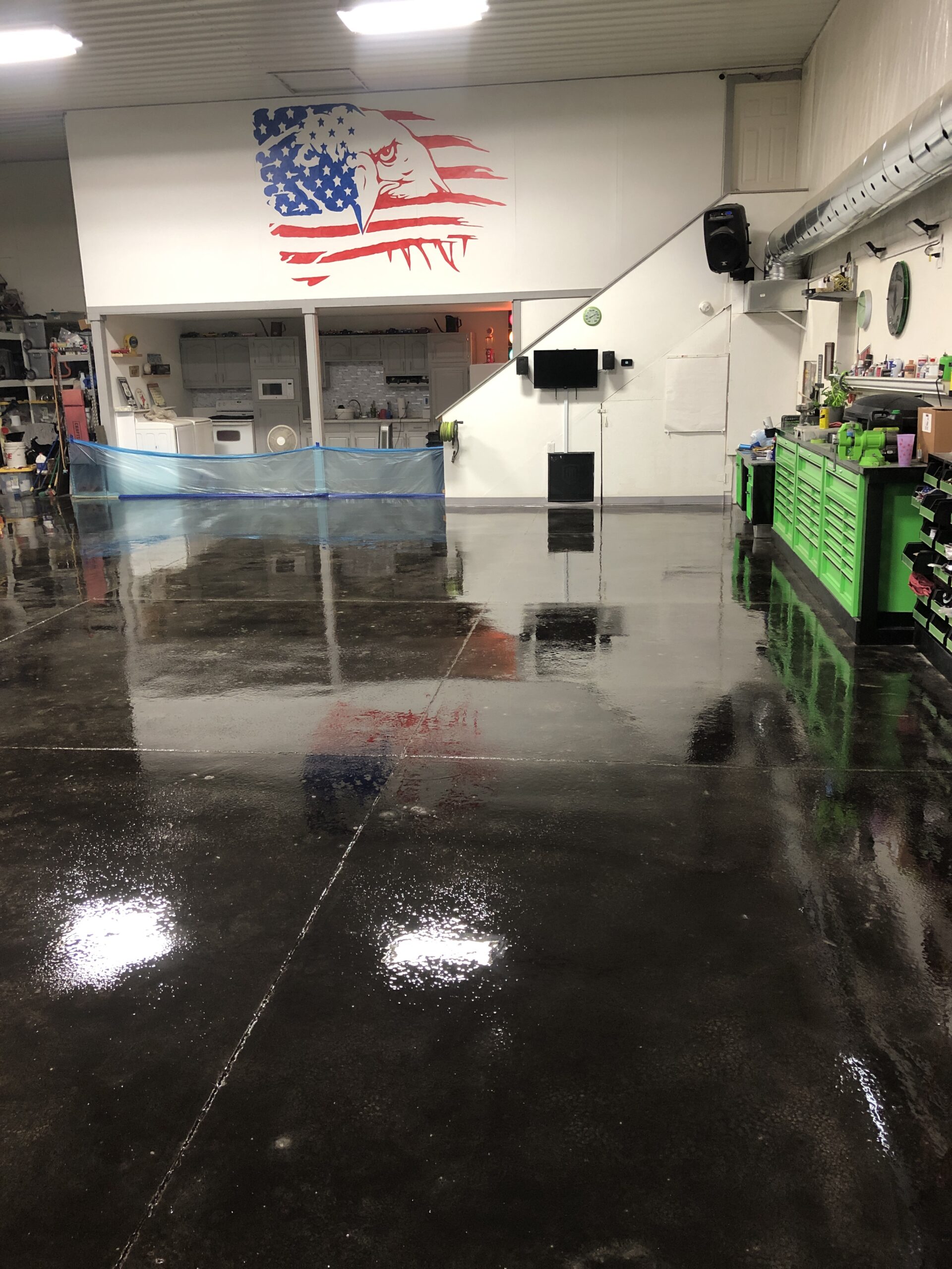 Finished barn shop floor with a reflective finish from the black concrete stain