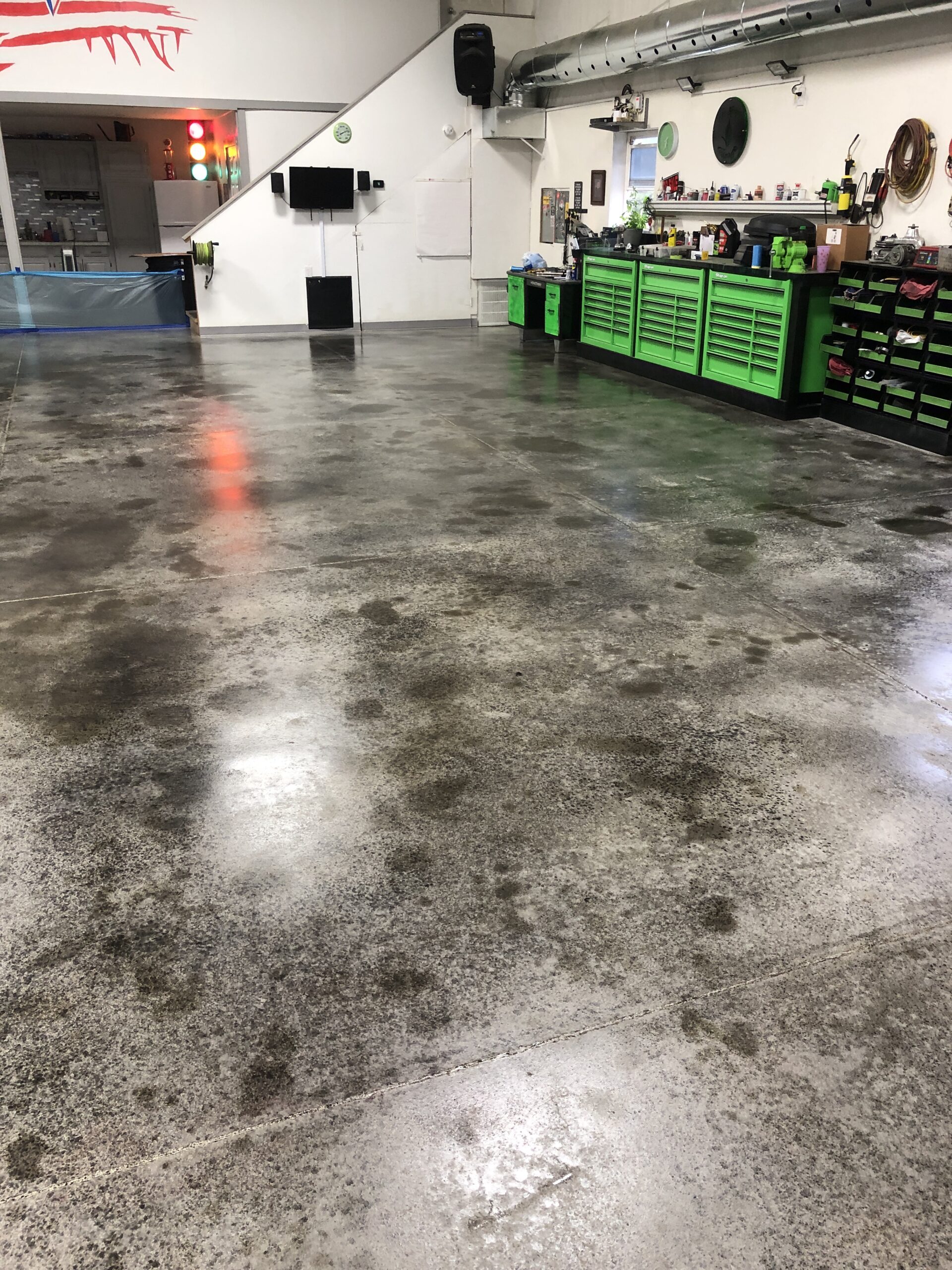 First coat of black concrete stain applied to barn shop floor