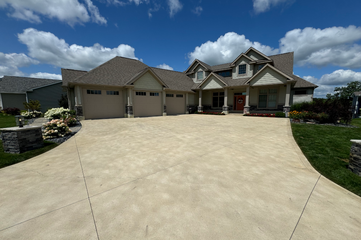 Scored-broom-finished-driveway-restored-buff-antiquing-stain fter photo of large scored and broom-finished driveway stained with Buff Antiquing™ Stain and sealed with EasySeal™ Satin, showing a smooth and refreshed finish.
