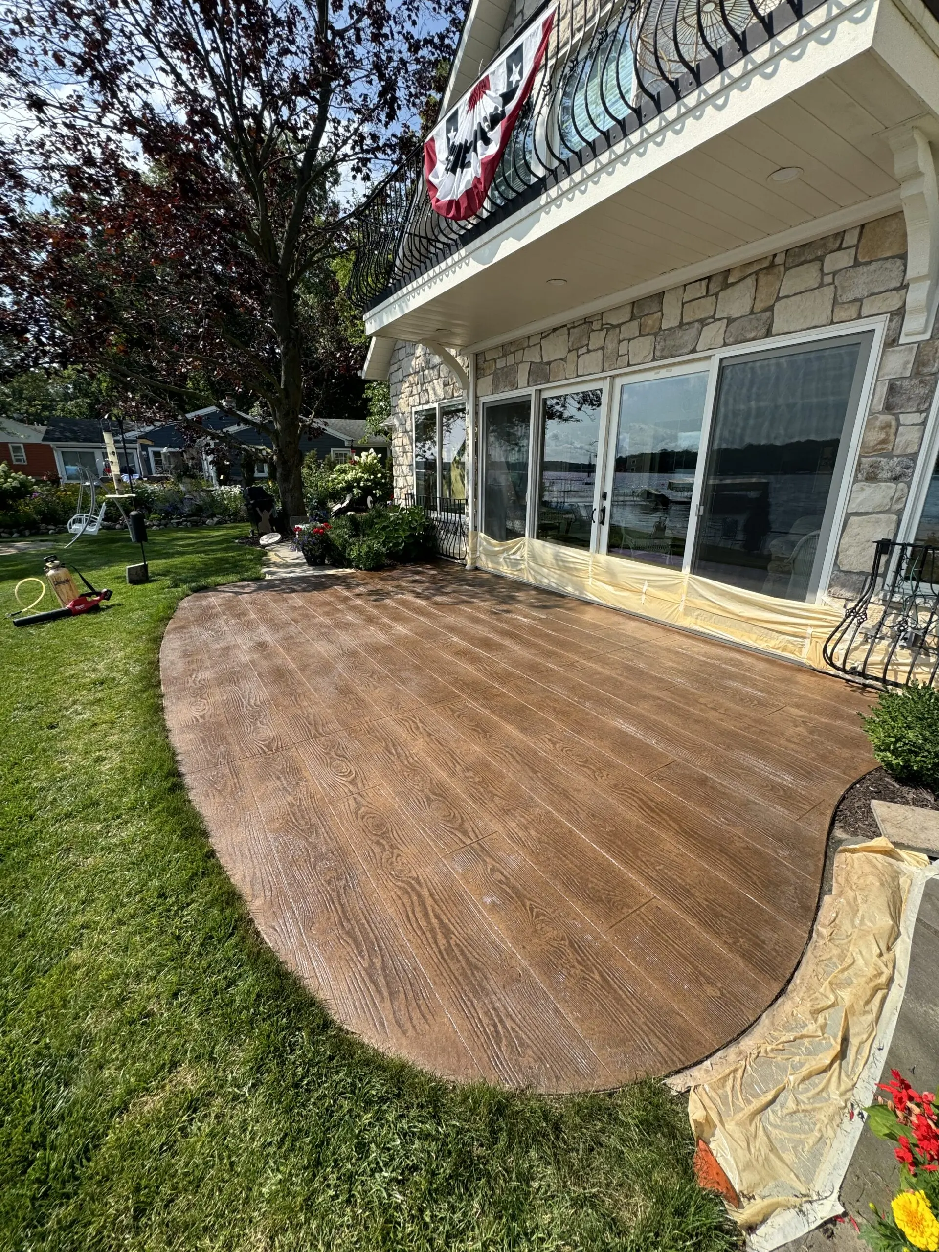 After staining: Stamped concrete patio finished with Driftwood stain to resemble wood planks.