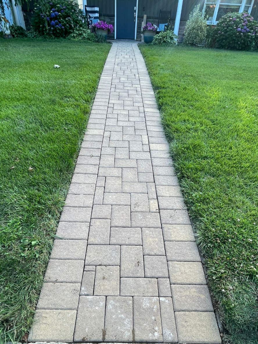 old-paver-walkway-before-portico-buff-charcoal-khaki-silver-gray-stains Before renovation: Old paver walkway before cleaning and releveling.