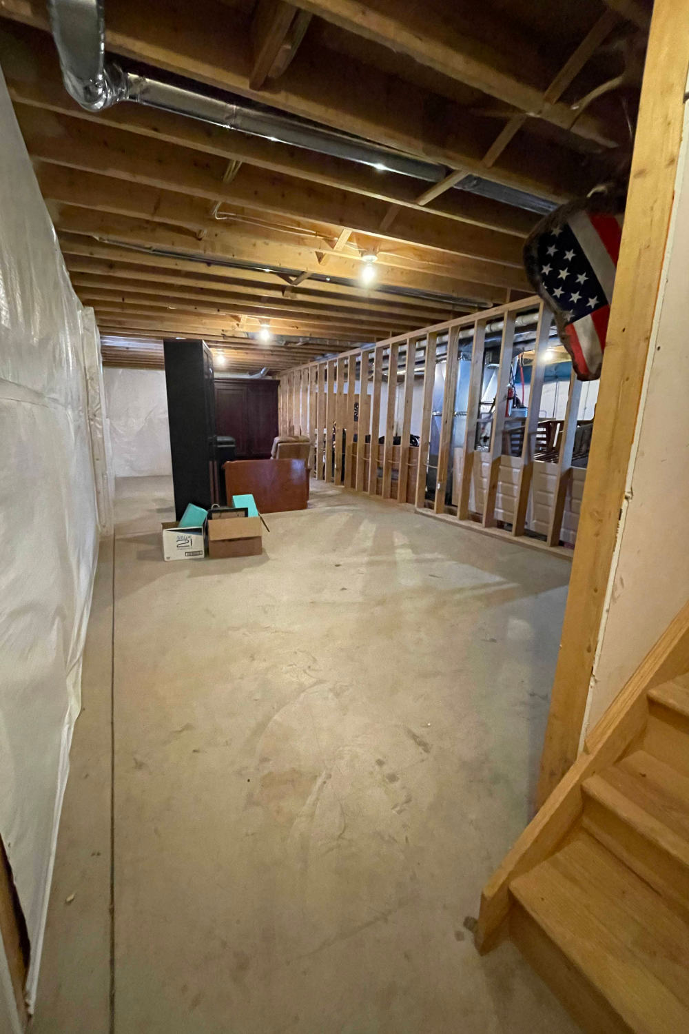 Bare concrete basement floor before staining and sealing.