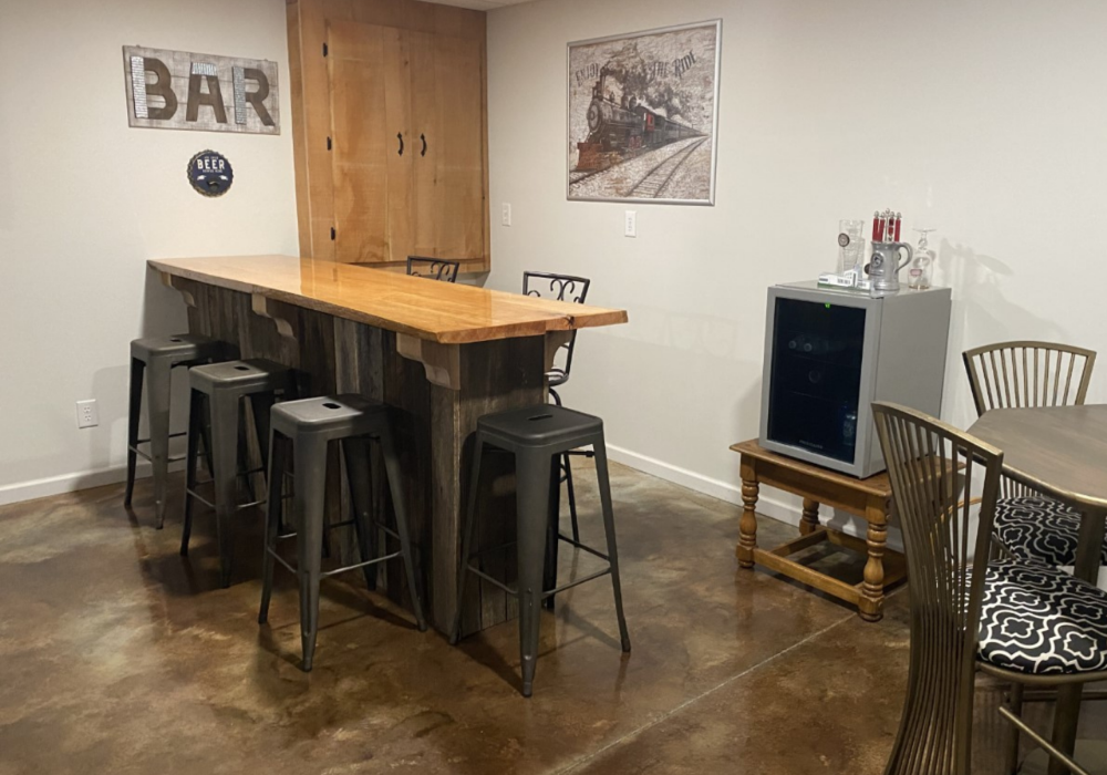 Rustic basement bar area with acid-stained concrete floors in Coffee Brown and Desert Amber