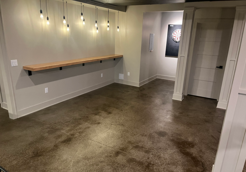 A close-up of the stained concrete floor, showing rich brown tones and natural variations in ColorWave Molasses