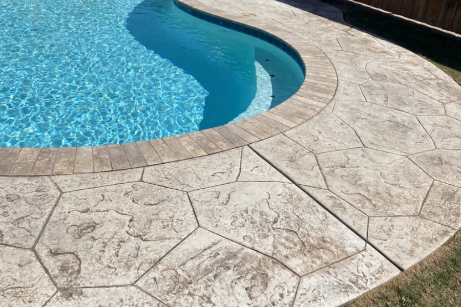 Faded stamped concrete pool deck