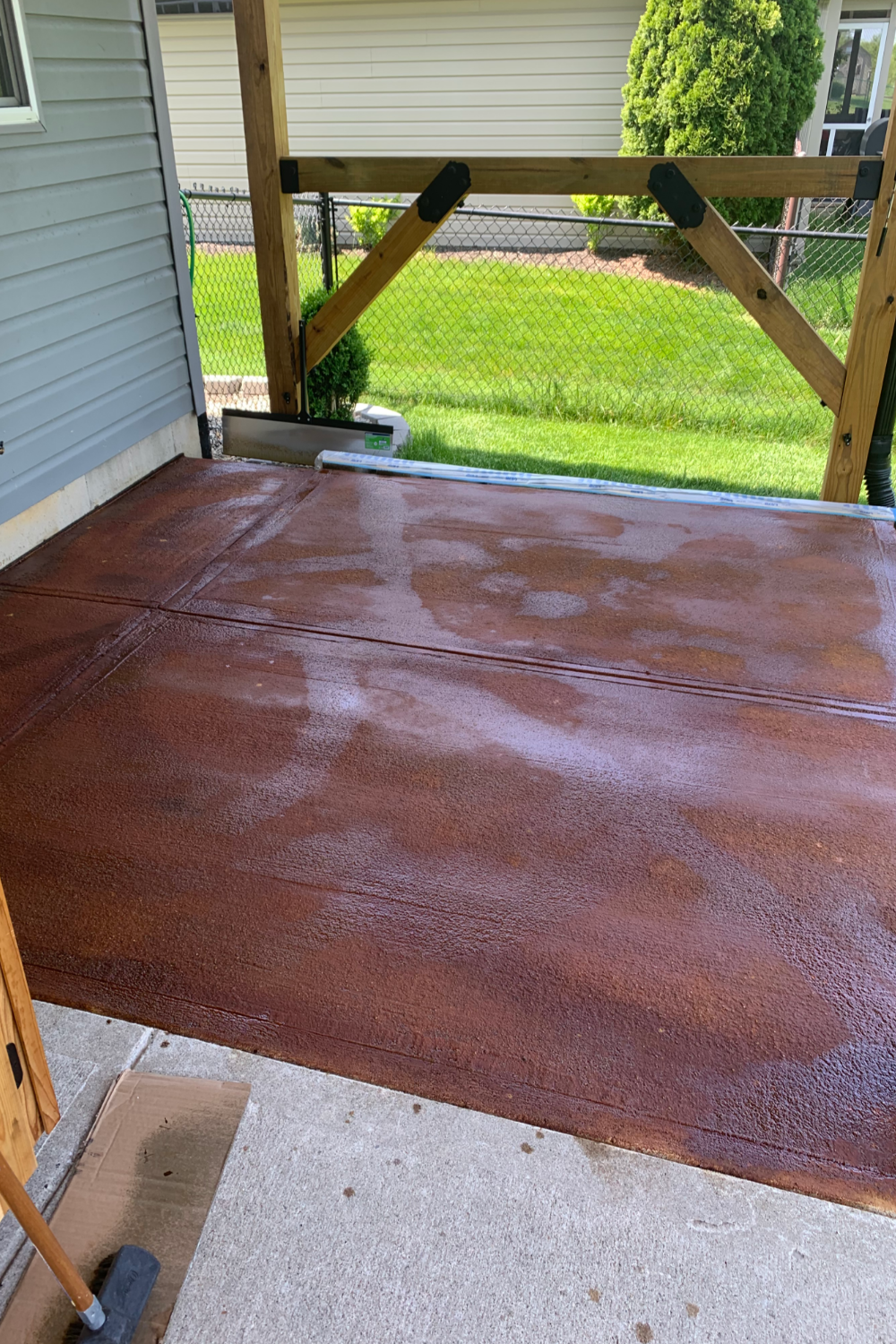 Staining underway to unify new and old concrete, with Coffee Brown EverStain application