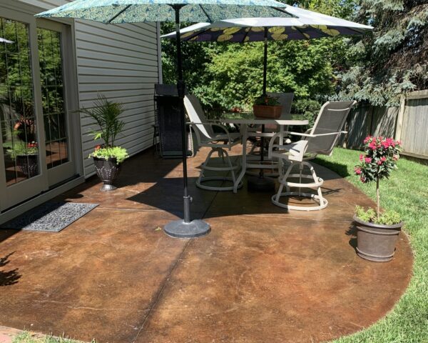 Restored concrete patio stained with Molasses and Mahogany ColorWave