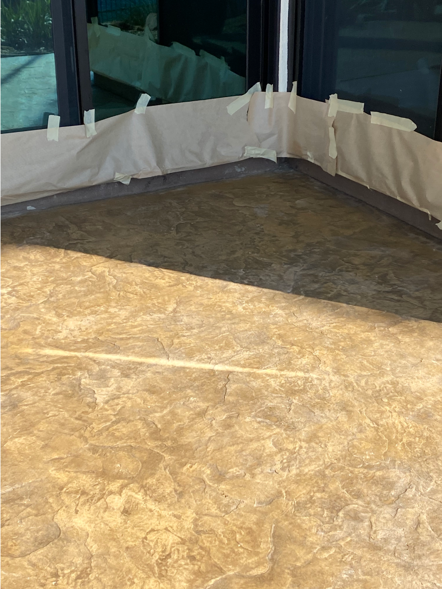 Hand-troweled patio after staining with Caf Royale Antiquing™ Stain Patio after staining with Café Royale Antiquing™ Stain, revealing rich brown tones and texture.