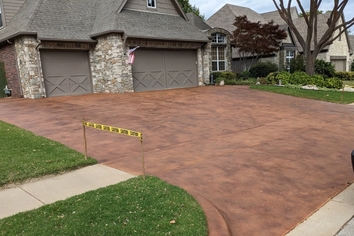 Large broom-finished concrete driveway stained in Portico Aztec Brown and Terracotta Large broom-finished concrete driveway stained in Aztec Brown and Terracotta showcasing a rich and even finish.