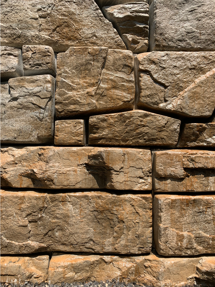 Retaining wall finished with Caf Royale EasyTint Retaining wall finished with Café Royale EasyTint™ Satin, showing rich brown tones and natural stone texture